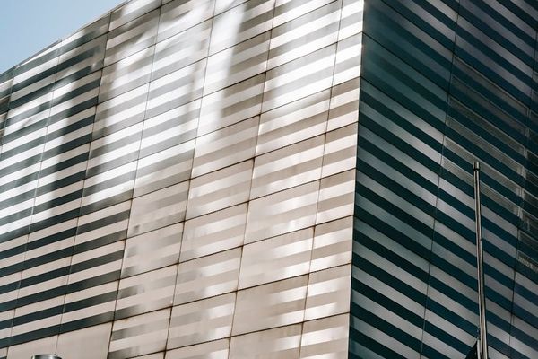 Modern office building exterior with glass facade in Almaty business district